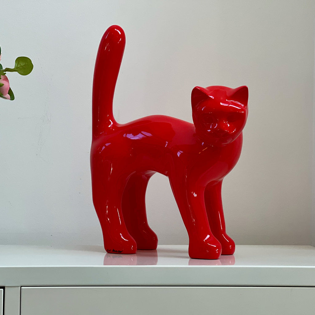 The Cat — Signal Red on a sideboard at home, real photo, 45 cm